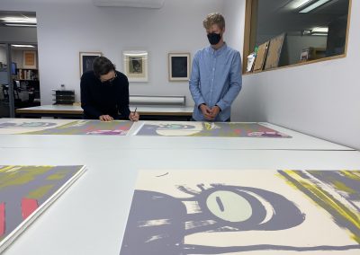 Ellen Berkenblit signing her prints, 2022