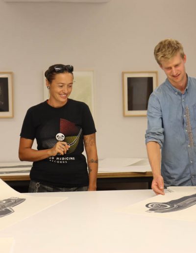 Rose Simpson signing her lithograph, Maria, with Tamarind Curator Ben Schoenburg and Graduate Assistant Kylee Aragon Wallis