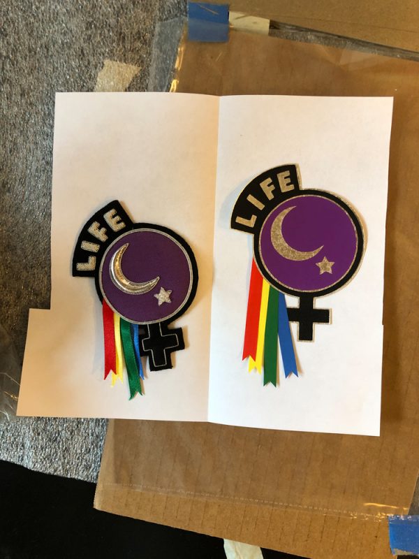 Handmade badge on left that Lesperance created for garments worn by Portland protesters; on right, LIFE badge recreated and hand-printed at Tamarind Institute.