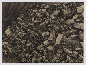 Two-color lithograph by Nina Elder with details of La Bajada mine in New Mexico. A pile of rock and debris in gray and black tones cascades from the upper left to the lower right of a horizontal composition. Part of the quarry wall is visible in the upper right corner.